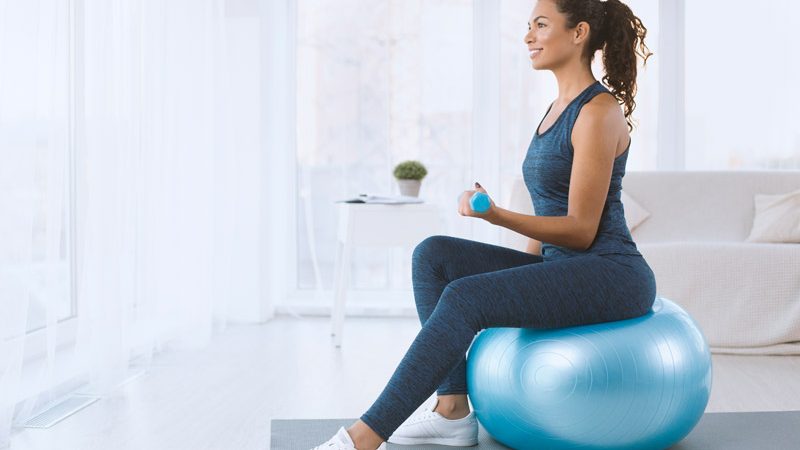 attractive-hispanic-lady-with-dumbbells-sitting-on-GEBTG2G.jpg